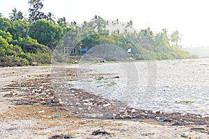 India, Goa, February 05, 2018. Empty plastic and glass bottles lie on the beach and pollute the ecology of the sea