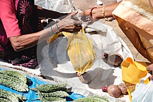 India.Indian people buy and sell fruits and vegetables on market from ground