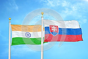 India and Slovakia two flags on flagpoles and blue cloudy sky