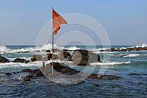 India, West Bengal, Cape Comorin Kanyakumari.   Red flag in the place of Confluence of Three Seas