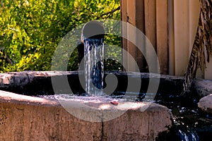 Indian agriculture water tank with water coming out of a tube well and flowing in the agricultural fields