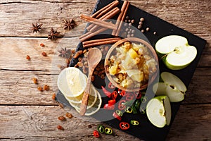 Indian apple chutney with ingredients close-up on the table. Horizontal top view