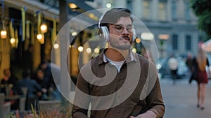 Indian Arabian male man teen gen z happy guy student businessman tourist in modern wireless headphones having fun listen