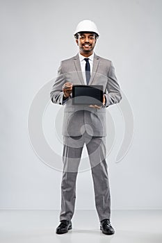 Indian architect in helmet with tablet computer