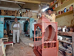 an indian artist making wooden temple at art wworkshop in India January 2020