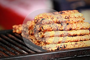 Indian asian chicken tikka, shish, kofta kebabs marinated in spices on charcoal barbeque at culture festival market