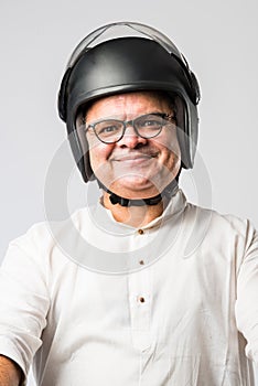 Indian asian senior man wears helmet