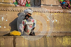 Indian beggar sitting on the street.