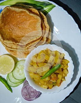 Indian Bengali Food Puri or Luchi with Aloo Sabji . Indian Poori is a bread deep fried in refined oil.