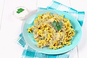 Indian biryani with chicken, yogurt and spices in a plate on a wooden table. New Year's, Christmas dish.