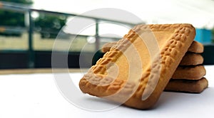 Indian biscuits stacked over white background