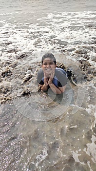 Indian boy pose for a photo at sea