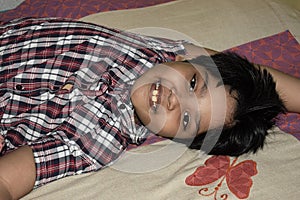 indian boy taking rest in a joyous smiling face