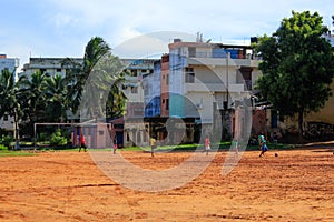 Indian boys playing cricket game on the playground in park. Kanyakumari, India