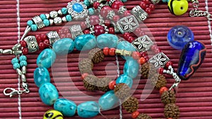 Indian bracelet armlet and beads rotating on bamboo mat