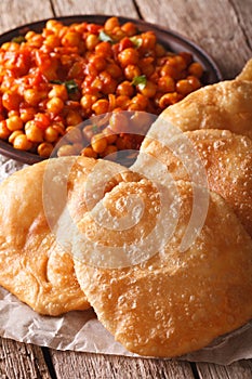 Indian bread puri and chana masala macro. Vertical