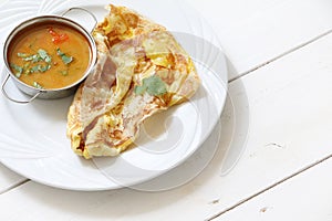 Indian bread or Roti telur with curry sauce