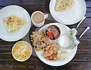 Indian breakfast - bread, spices, omlet, masala tea, corn flakes with milk.
