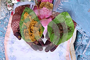 Indian bride having turmeric and henna on betal leaf