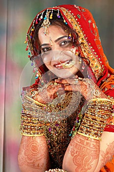 Indian bride in her wedding dress showing bangles