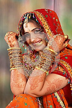 Indian bride in her wedding dress showing bangles photo