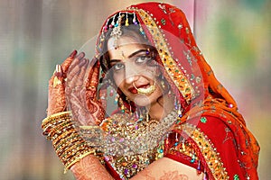 Indian bride in her wedding dress showing henna