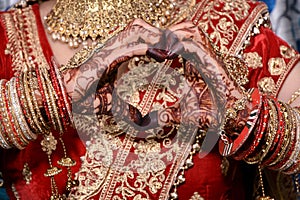 Indian bride making heart shape by her hands