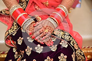 Indian bride showing her mehndi during her wedding in India