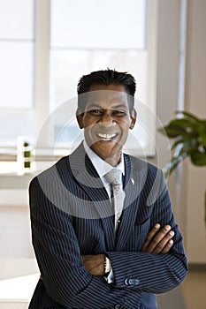 Indian Business Man Laughing with Arms Folded photo