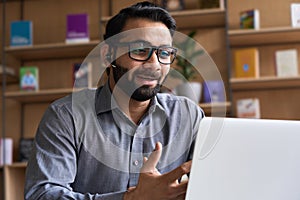 Indian business man speaking having virtual meeting on laptop.