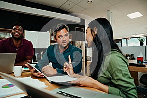 Indian business woman discussing work with colleague brainstorming ideas to present before meeting