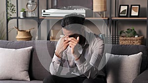 Indian Businessman Having Headache On Sofa After Working Day