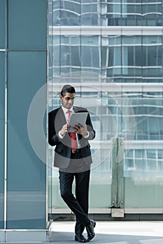Indian businessman using a tablet PC indoors