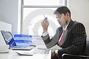 An Indian businessman working at office desk