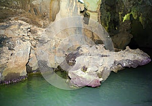 Indian Cave in Vinales, Cuba. Underground cave with stalactites and stalagmites, and river