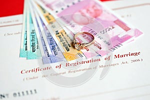 Indian Certificate of registration of marriage blank document and wedding ring with rupiah money