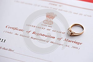 Indian Certificate of registration of marriage blank document and wedding ring on table