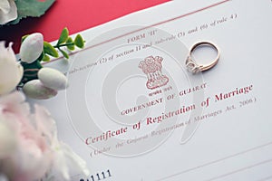 Indian Certificate of registration of marriage blank document and wedding ring on table