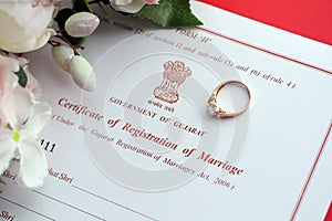 Indian Certificate of registration of marriage blank document and wedding ring on table