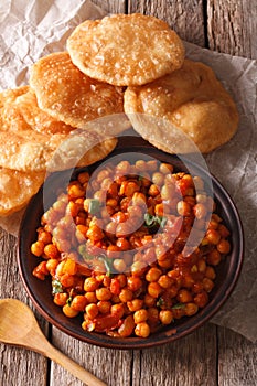 Indian Chana masala and puri bread close-up. Vertical