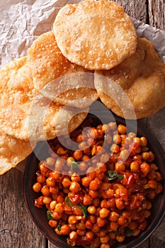 Indian Chana masala and puri bread close-up. Vertical top view