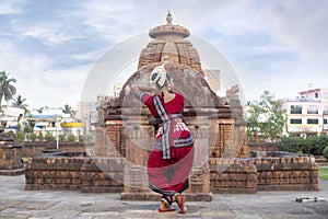 Indian Classical Odissi dancer posing at Mukteshvara temple.