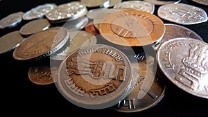 Indian coins collection lighting on black background