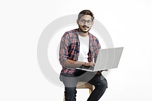 Indian college student using laptop on white background