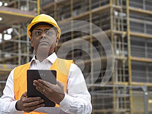 Indian construction worker using a digital tablet