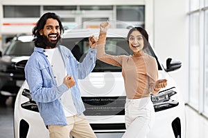 Indian Couple Celebrating Buying New Car, Dancing In Dealership Office