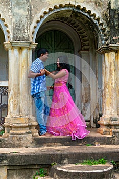 Indian couple in love enjoy a moment of happiness in old structure. Bengali couple on romantic mood. Selective focus on woman face