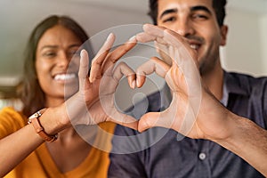 Indian couple making heart with hands