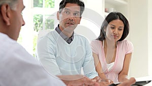 Indian Couple Meeting With Financial Advisor At Home