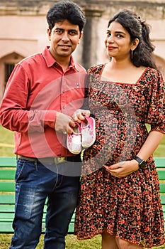 Indian couple posing for Maternity shoot pose for welcoming new born baby in Lodhi Garden in Delhi India, Maternity photo shoot